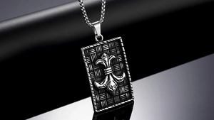 Macro view of vintage punk shield pendant with fleur-de-lis relief and woven texture detail