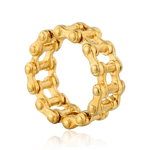 Detail shot of the golden bicycle chain structure and punk industrial style metal ring
