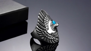 Close-up of vintage eagle ring with turquoise stone inlay and distressed metal texture