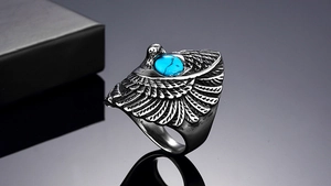 Detailed close-up of eagle ring with blue turquoise inlay in vintage steel finish