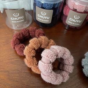 Elastic knit hair ties set in wine red and pastel tones with clear cylindrical storage jar