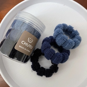 Detail of high-elasticity plaid hair ties with honeycomb texture in a storage jar