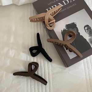Matte rectangular cross hair claw clips in beige, black, brown and caramel colors