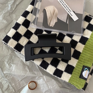 Detail of large matte black square hair claw clip with geometric hollow resin design