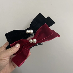 Elegant red and black velvet bow hair clips with white pearls in a vintage retro style
