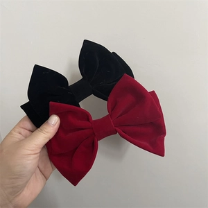 Detail of red and black velvet bow hair clips with elegant multi-layer craftsmanship
