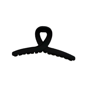 Minimalist matte black rectangular hair claw clip with crossed design on white background