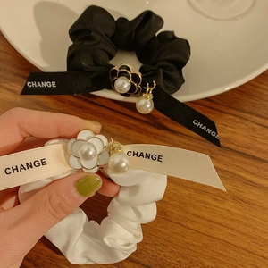 Elegant satin bow scrunchies with camellia flower charm and pearl detailing