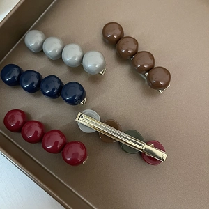 Candy-colored round bead hair clips set with glossy resin finish and gold metal spring base