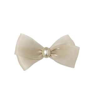 Elegant champagne organza bow hair clip with central pearl and golden beads on white base