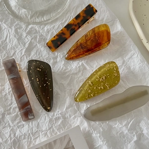 Detailed set of geometric acetate hair clips in assorted amber and marble patterns