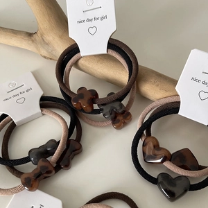 Elegant leopard print resin heart hair ties set with tortoiseshell pattern on wood
