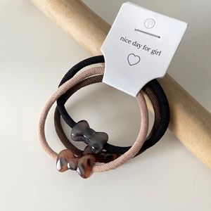 Three-piece leopard print hair tie set with resin bow detail on white display card