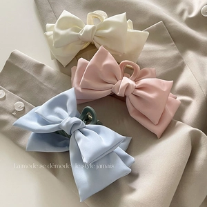 Trois pinces à cheveux en satin avec nœuds élégants en coloris crème, rose et bleu clair