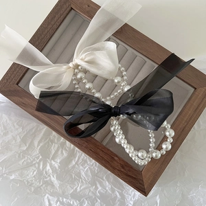 Elegant double-layered tulle bow hair scrunchie with faux pearl charms in black and white