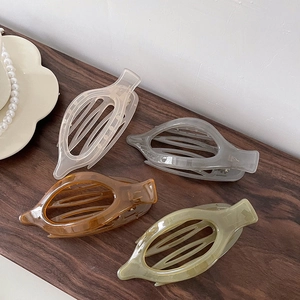 Set of four large acrylic hair claw clips in beige, grey, amber and green for women