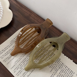 Brown and olive green transparent acrylic hair clips in a hollow oval design