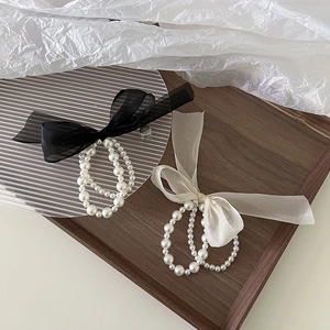 Elegant double-layered pearl and tulle bow hair ties in black and beige colors