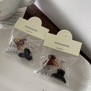Detailed view of mini jelly bow hair clips set in transparent and amber colors