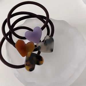 Set of four elegant jelly-colored heart hair ties in assorted acetate textures and patterns