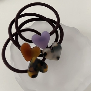 Minimalist jelly heart elastic hair ties in acetate marble patterns and amber colors