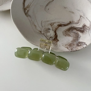 Detailed view of square green translucent resin hair claw clip with jade texture