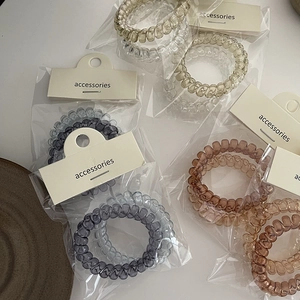 Elastici per capelli a spirale in colori neutri con confezione per la vendita