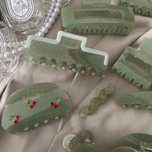 French checkerboard hair claw set with mint green acetate finish and cherry crystal details