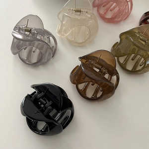 Detail showing various jelly colors of semi-transparent resin hair claws in a flat lay view