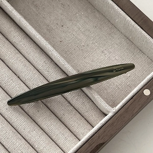 Elegant emerald green marble hair clip with Barrette La France lettering on wood box