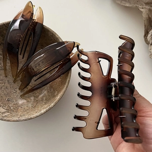Détail des pinces à cheveux en résine ambrée et grande pince crabe au fini brillant