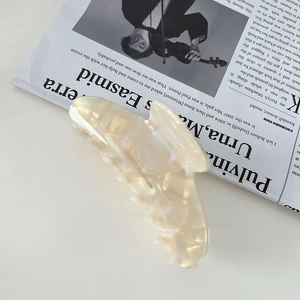 Detailed macro view of the iridescent cream acetic hair claw with France Handmade text
