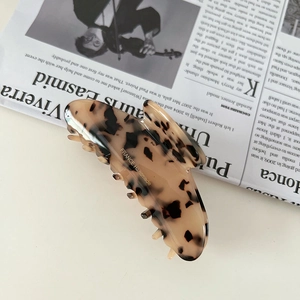 Detail of tortoise shell acetate hair claw clip with gold France Handmade logo