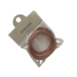 Translucent spiral telephone wire hair ties in smoky purple color with card packaging