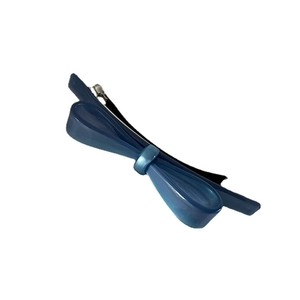 Elegant navy blue acetate bow hair clip with silver metal spring fastener on white background