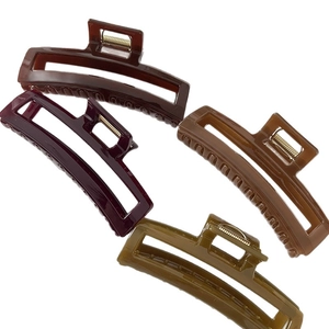 Set of four glossy hollow rectangular hair claws in deep autumn tones with metal springs