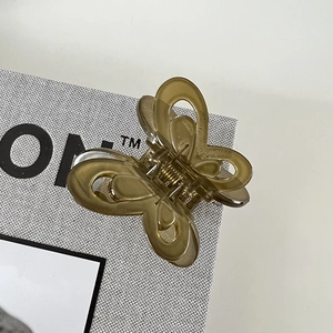 Close-up of translucent butterfly hair claw clip with a strong gold metal spring