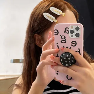 Minimalist white leaf acetate hair clips with gold metal base worn by a female model
