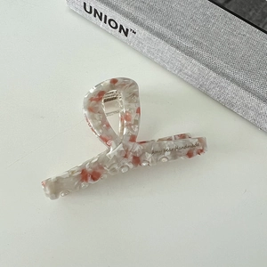 Elegant white acetate claw clip with orange stone patterns and handmade lettering