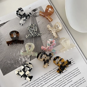 Elegant acetate claw clips set in leopard, marble, and checkered patterns for women