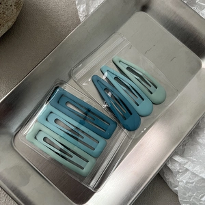Detail view of 6-piece Morandi matte blue hair clips in rectangle and teardrop shapes
