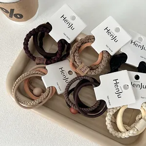 Elastic hair tie set in earthy tones featuring woven textures and decorative beads