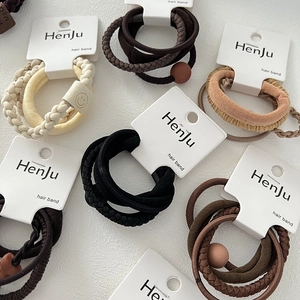 Close-up of assorted elastic hair bands in earth tones with matte bead details