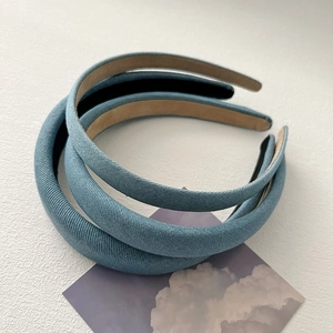 Three-piece set of textured light blue fabric headbands with padded sponge design