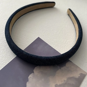 Detail of dark blue denim headband showing the thick padding and anti-slip lining