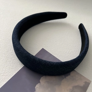 Close-up of blue denim headband showing twill fabric texture and black non-slip lining