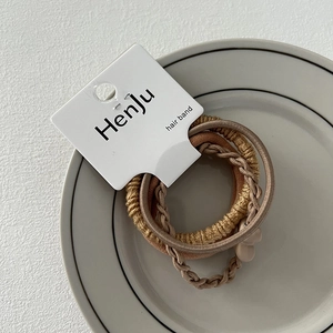 Detailed macro view of three textured elastic hair bands in elegant coffee brown tones