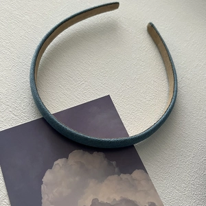 Detail of blue denim padded headband showing non-slip lining and fabric texture