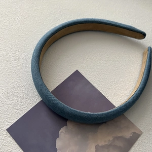 Detailed view of the blue textured fabric on a padded headband with anti-slip inner lining