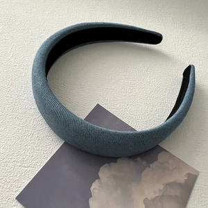 Detail of blue corduroy padded headband with sponge texture and non-slip inner lining